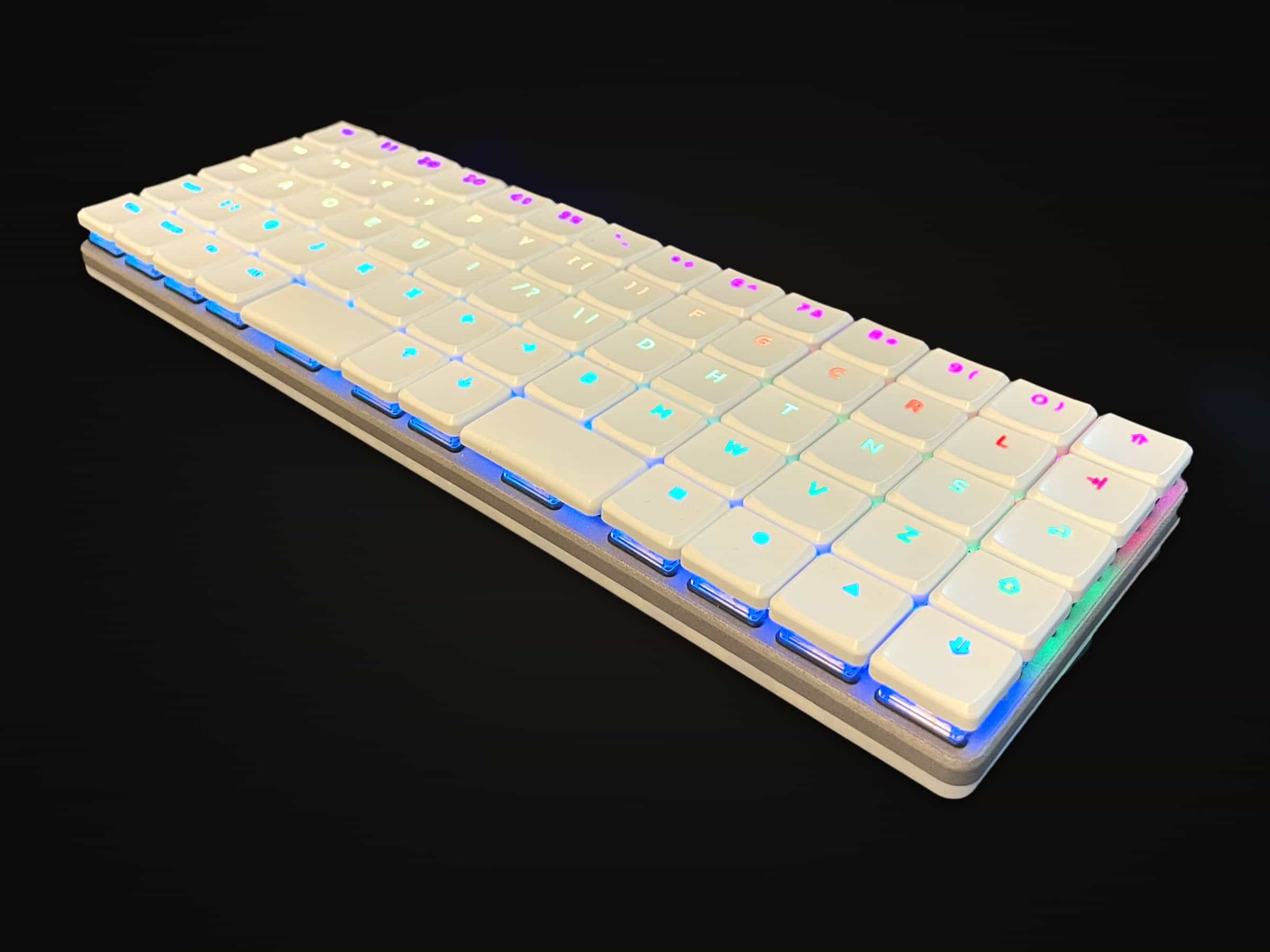 The Breeze V1 in white, its shine-through legends lit in a rainbow.
