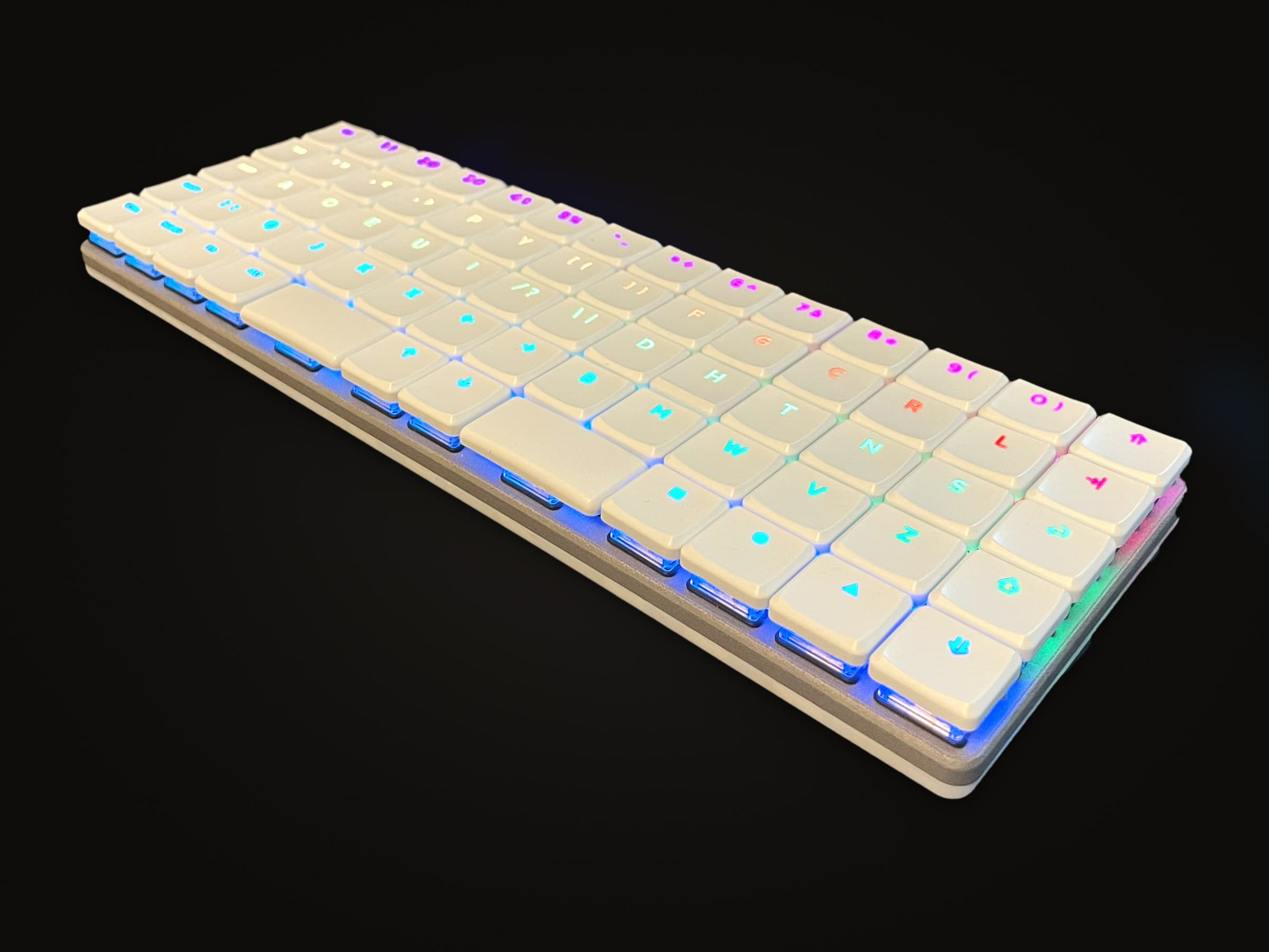 The Breeze V1 in white, its shine-through legends lit in a rainbow.